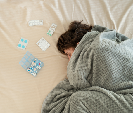 close-up-woman-bed-with-pills 1